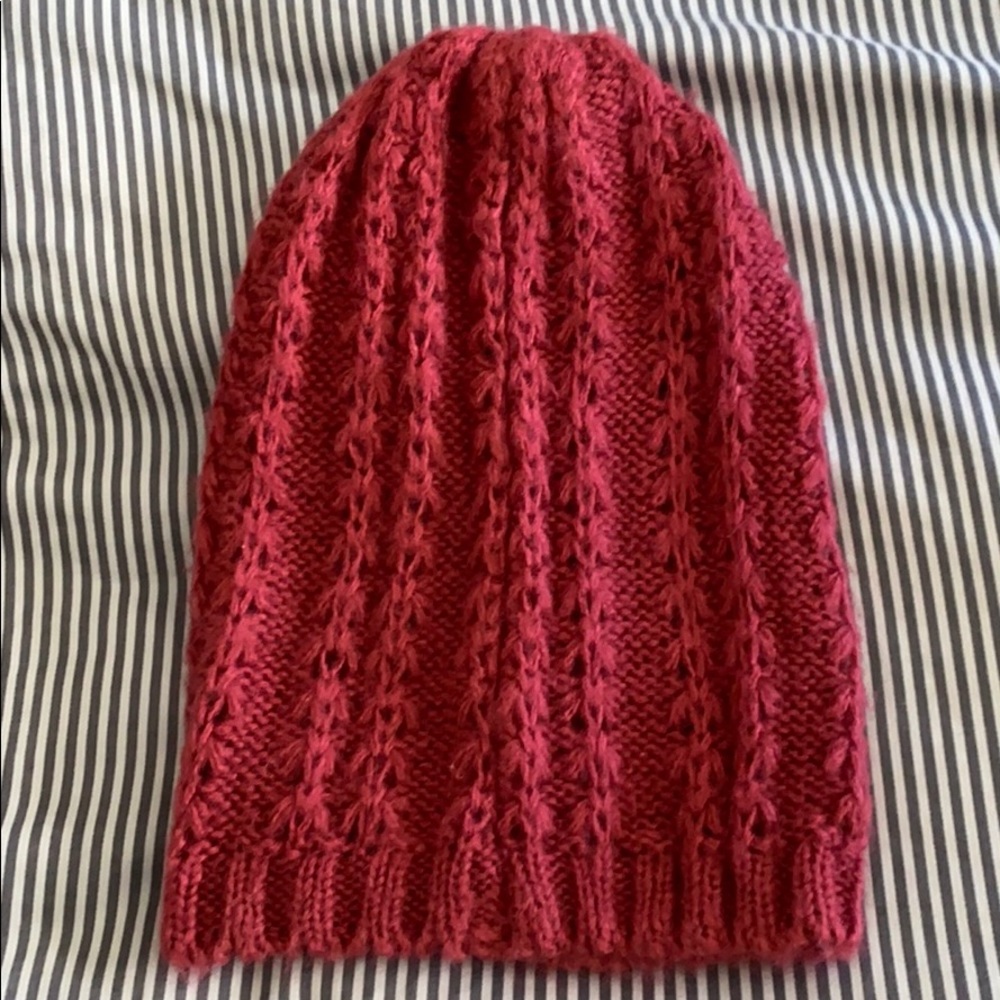 Slouchy crocheted beanie in a raspberry color.